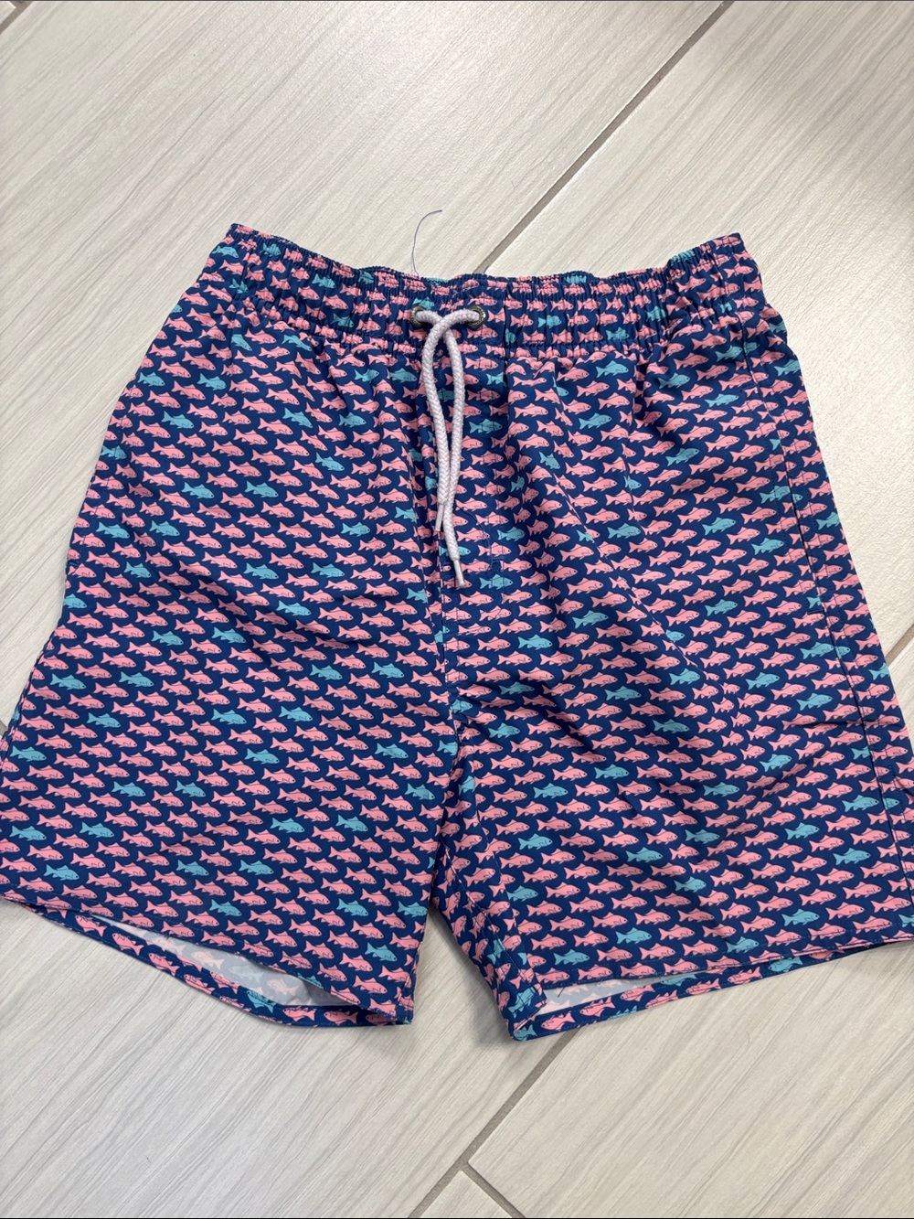 Boy’s Lined Navy Swim Trunks with Pink Fish Print from Dillard’s 14/16